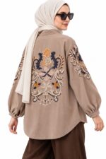 Cardigan long beige foncé, avec broderies florales colorées, porté par une femme voilée, vue trois-quarts dos